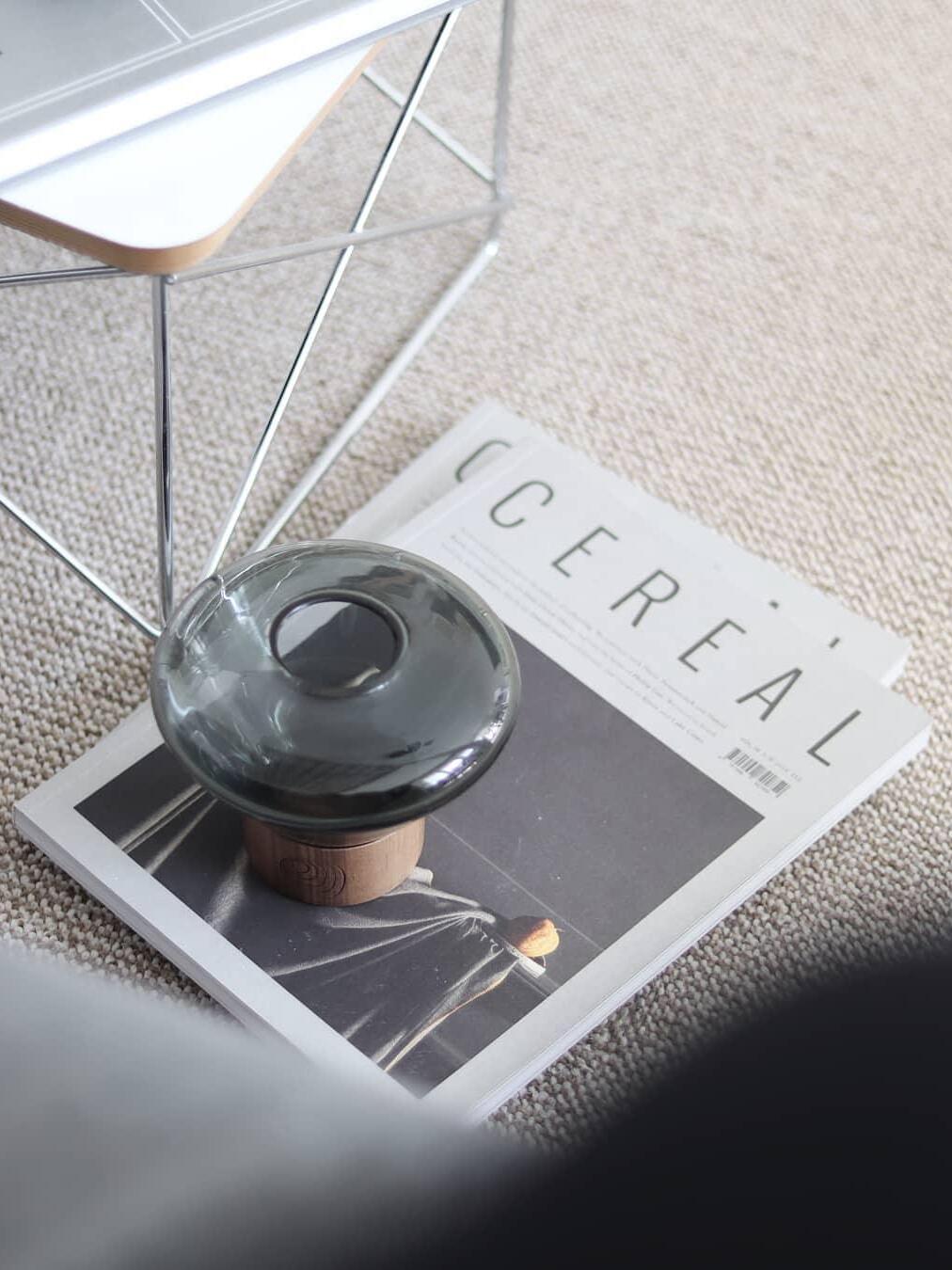 Overhead smoky rounded glass shade with top opening on Cereal book