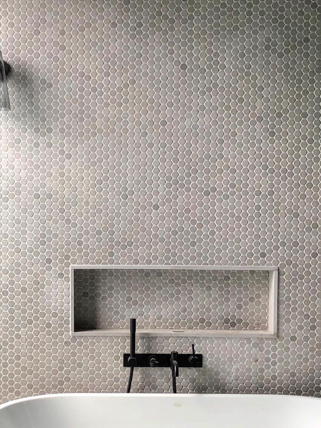 Small wall fixture in a tiled bathroom scene