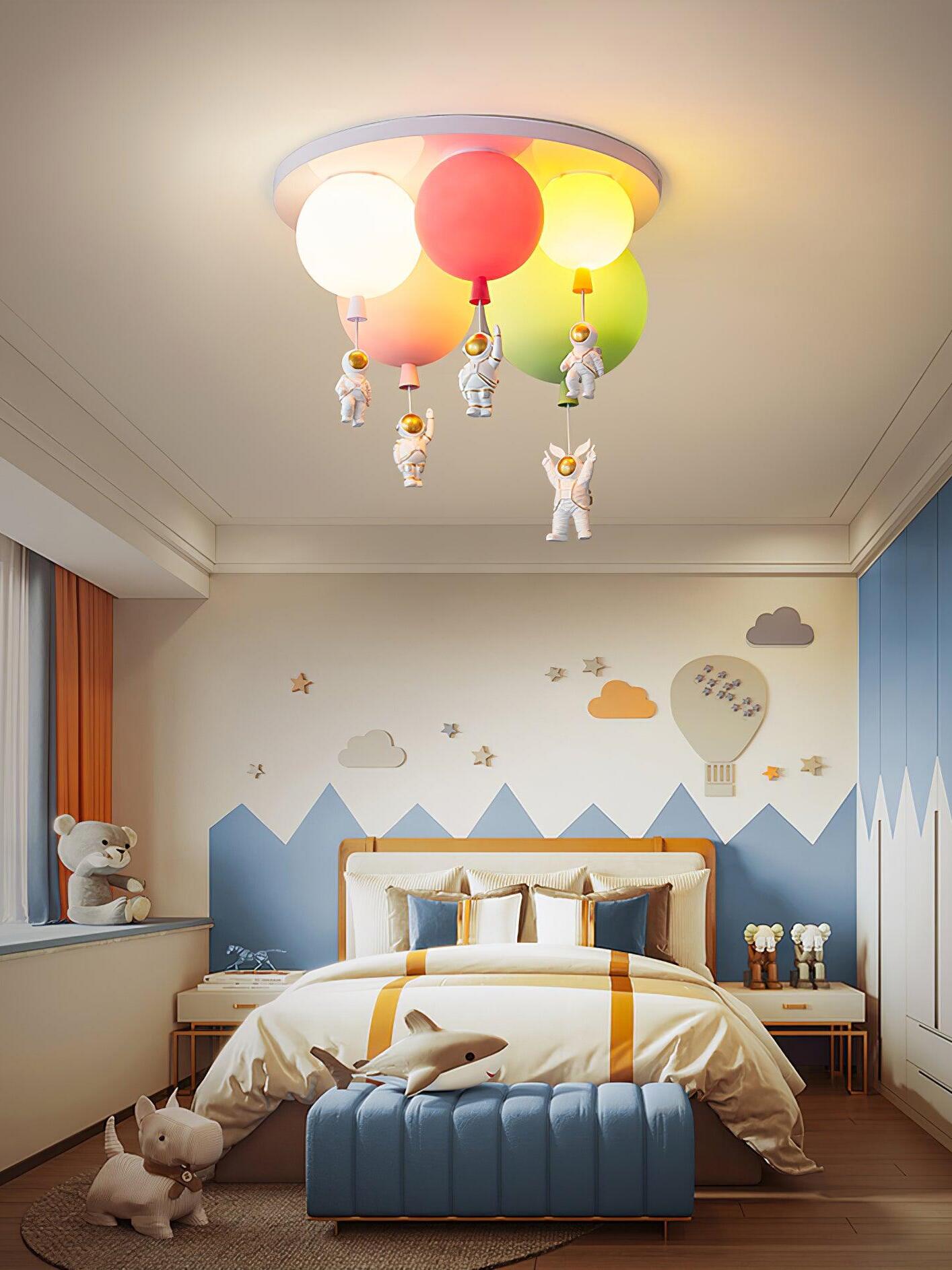 Five illuminated balloon shades above a blue bed