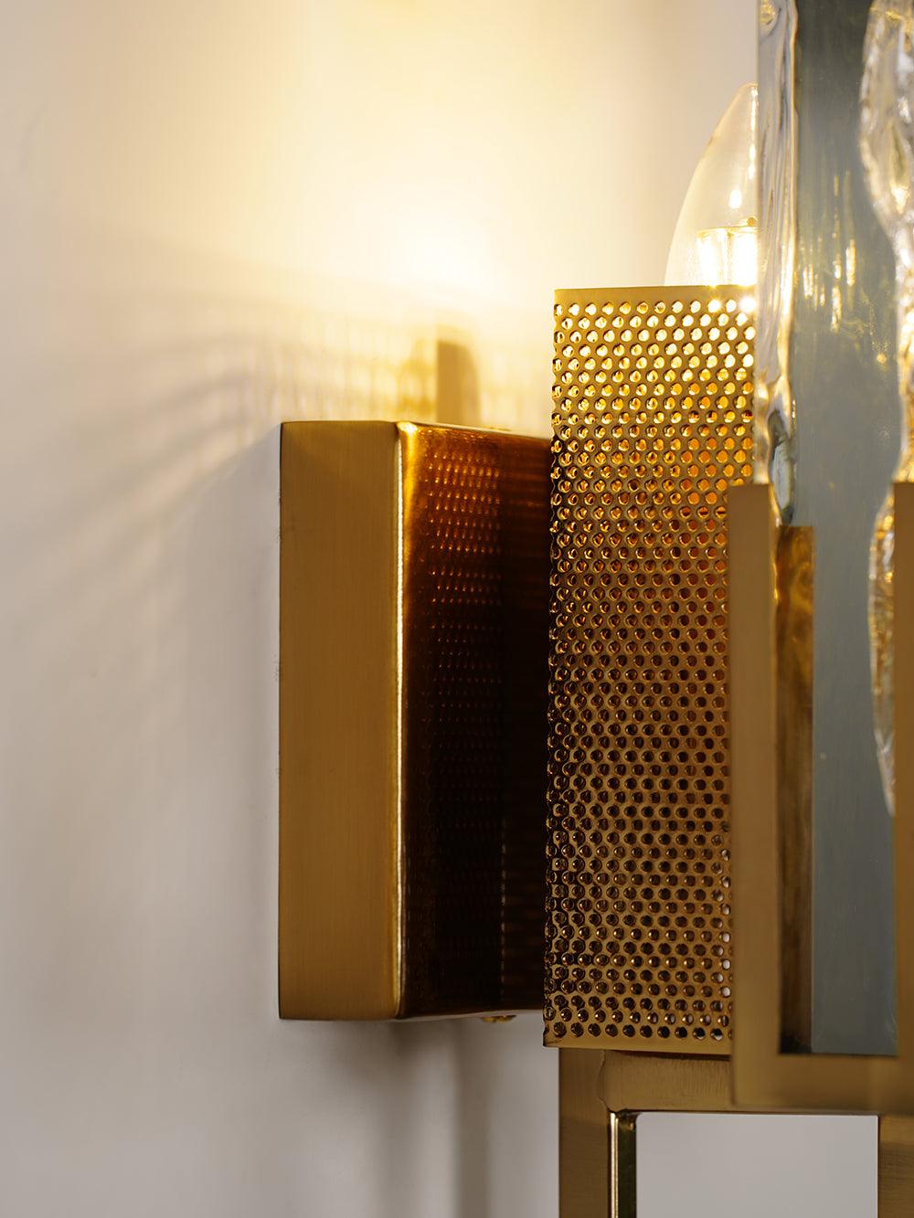 Wall plate and perforated guard beside illuminated bulb