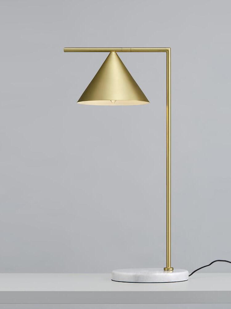 Gold-tone table lamp and pale marble base with black cord