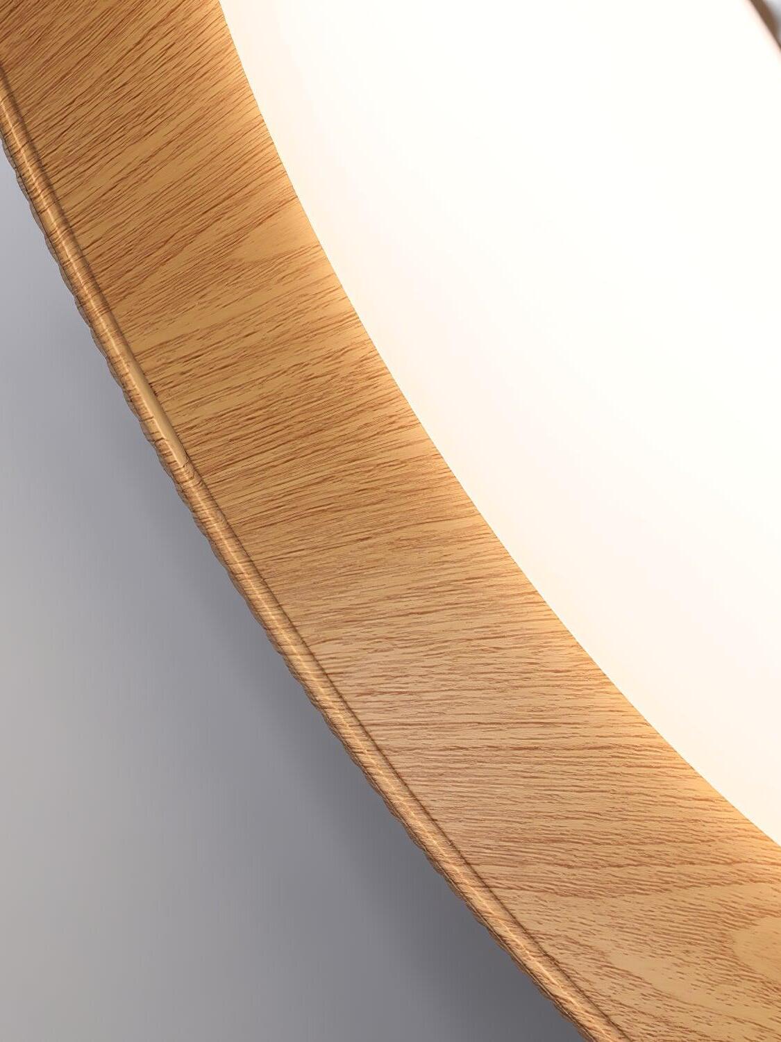 Close-up of wood-grain-looking inner surface beside the white circular diffuser of the ribbed pendant