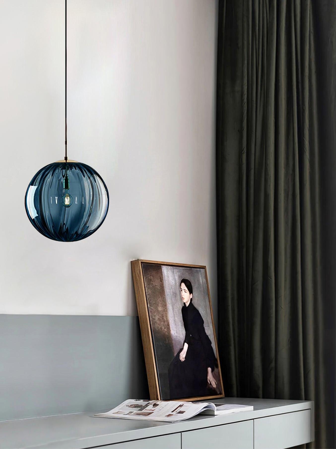Dark blue globe beside a portrait and curtains