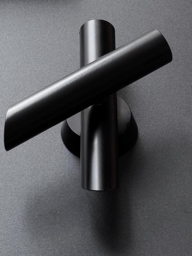 Close view of black tubes and round wall plate
