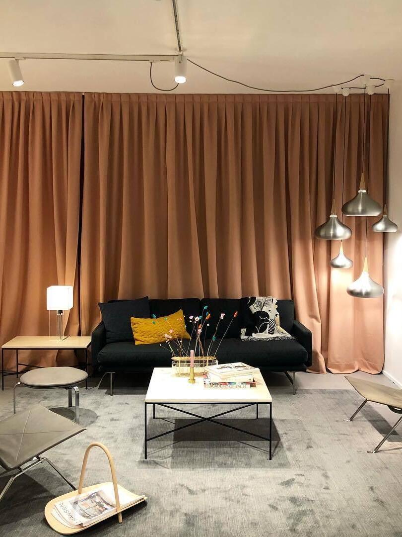 Metal pendants in a living room with brown curtains