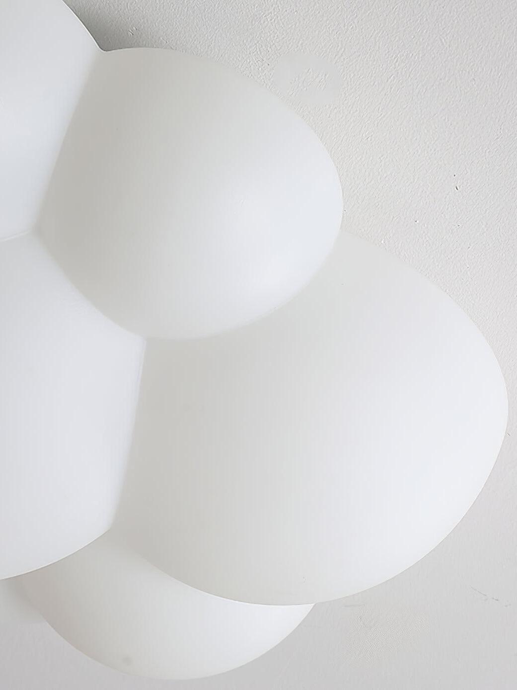 Close-up of the unlit white rounded surface and joined lobes of a Nuage fixture