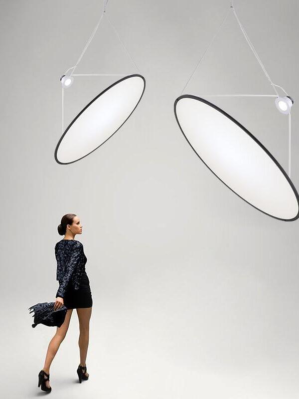 Two pale disc pendants with thin suspension lines