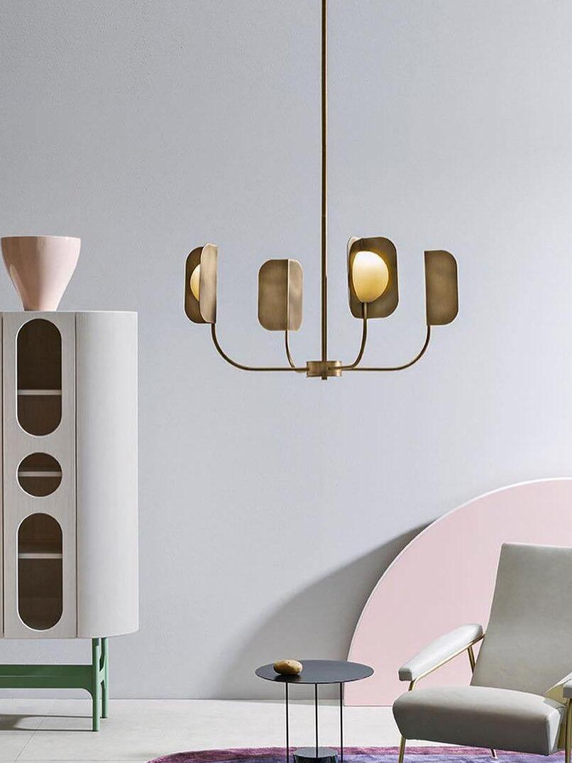 Small gold-coloured LEAF chandelier in a pale room