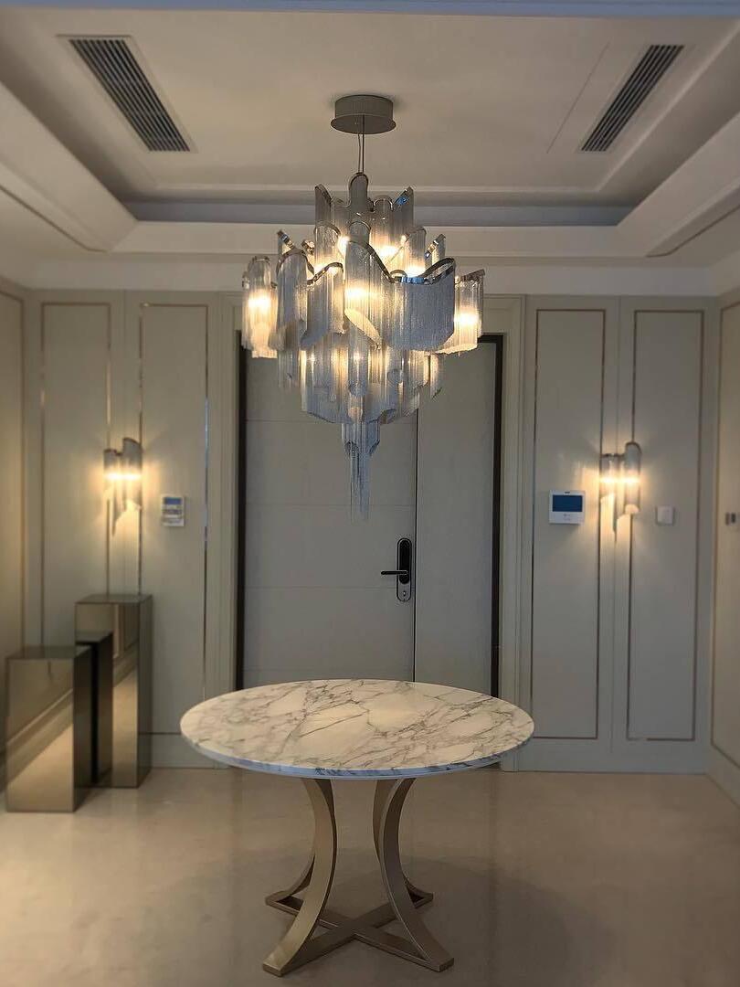 Chain-fringe chandelier above a small round table