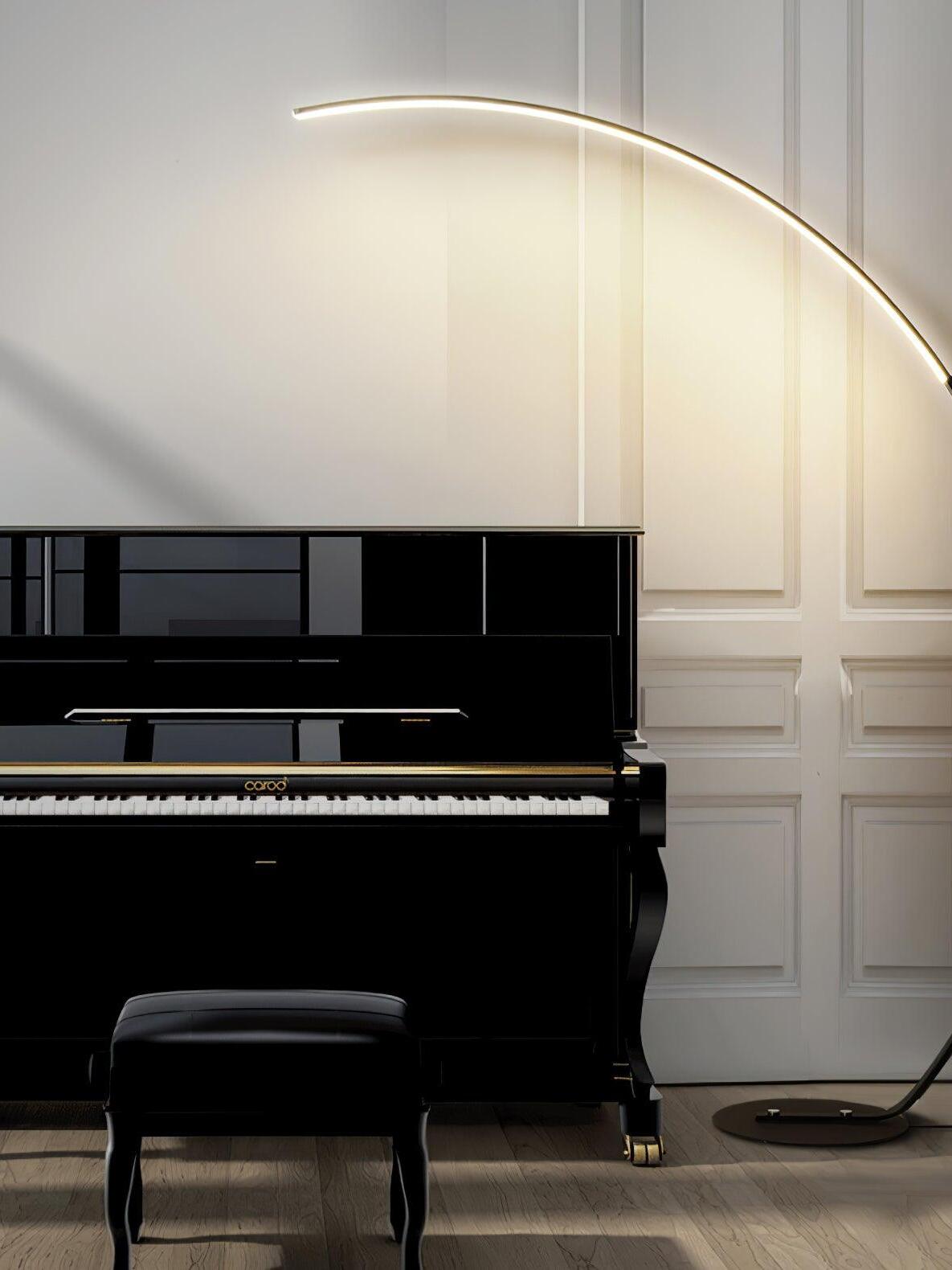 Black curved LED floor lamp beside piano