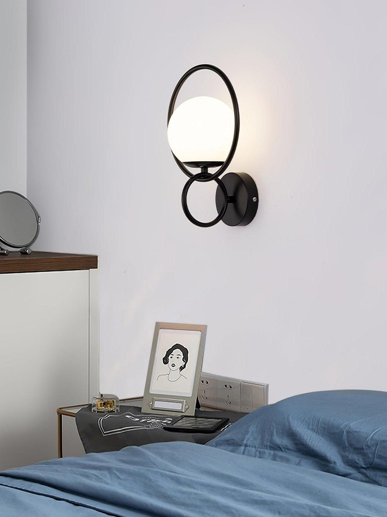 Black ringed white globe above bedside table