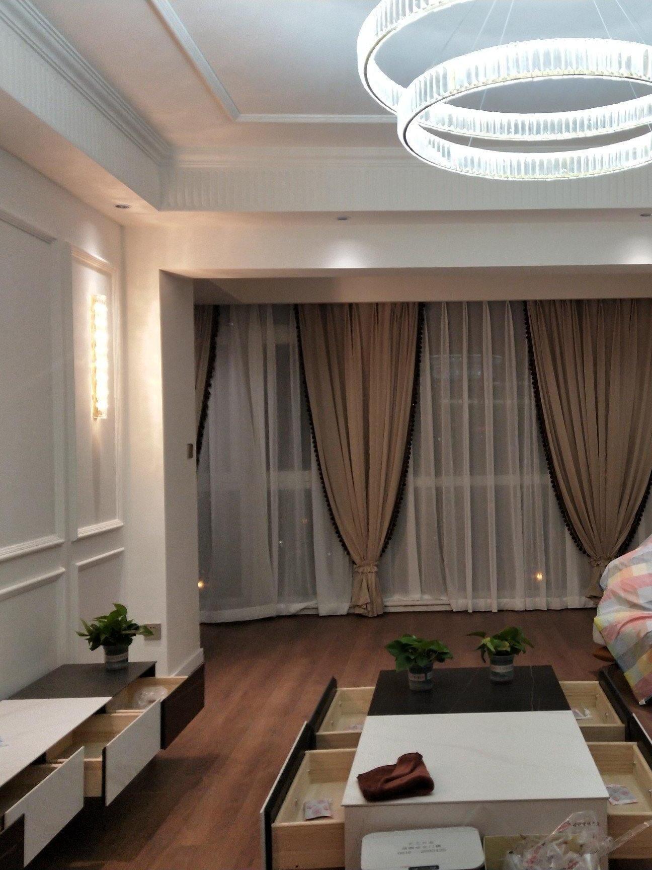 Living room with glass wall bar and separate ring chandelier