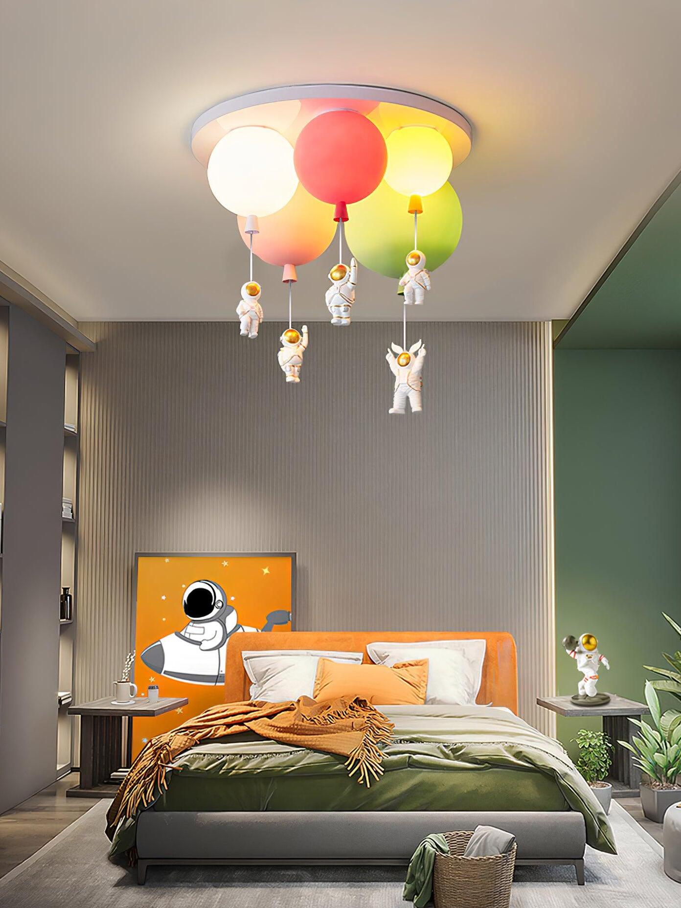 Astronaut ornaments hanging above a space-themed bed