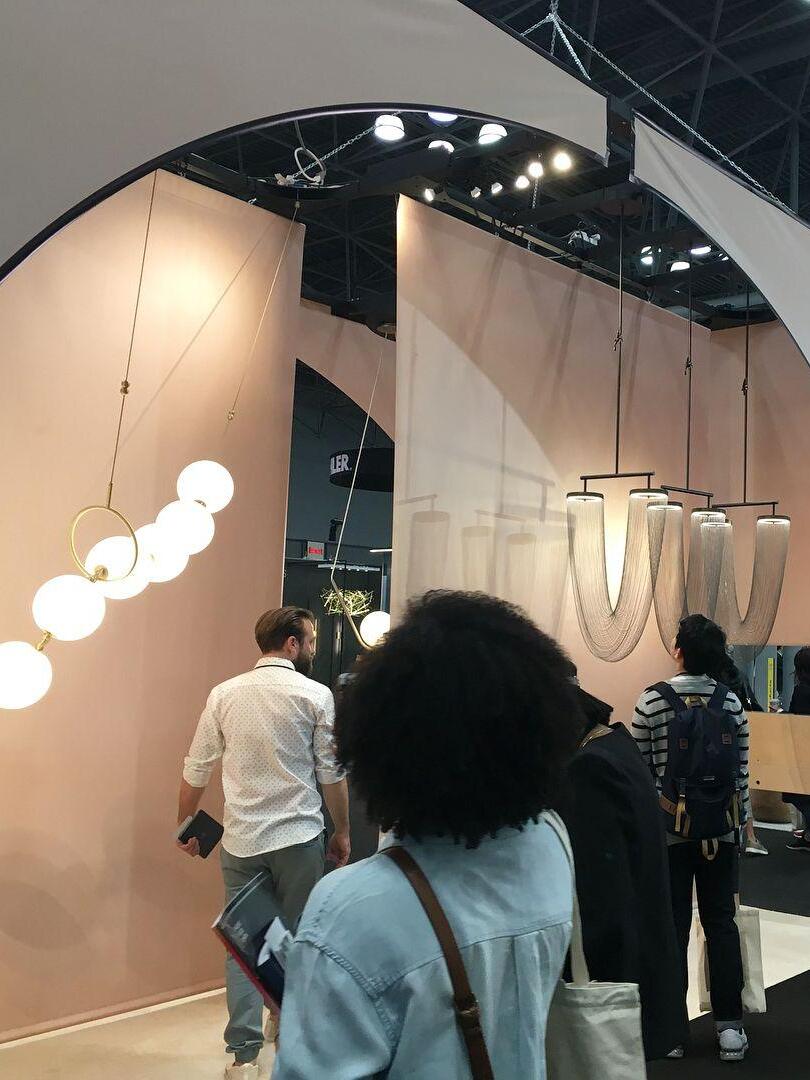 Chain lighting on a showroom wall with visitors