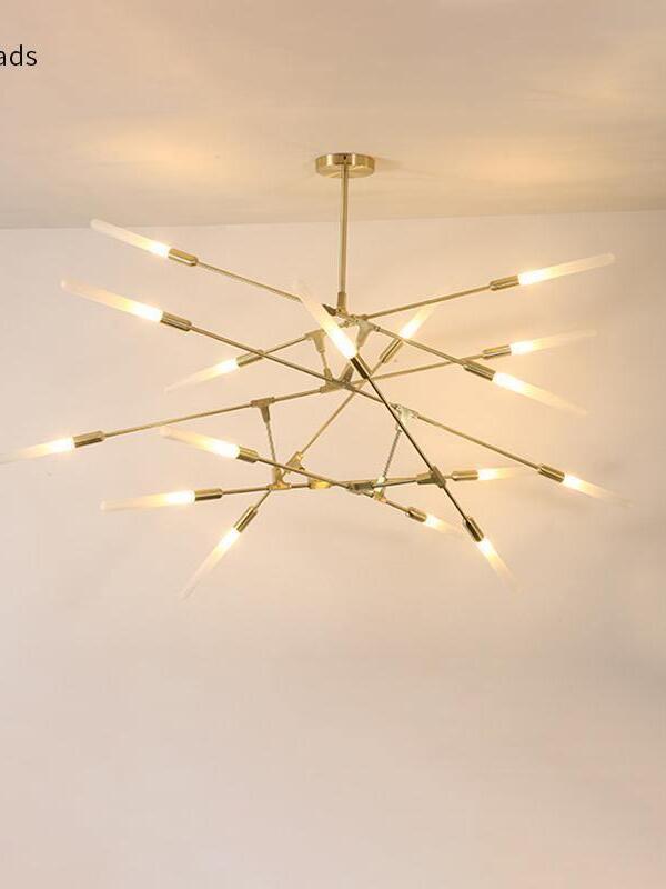 Wide Gold branch chandelier illuminated near a ceiling