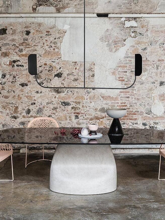 Black leaf-like fixture in a marble-patterned room