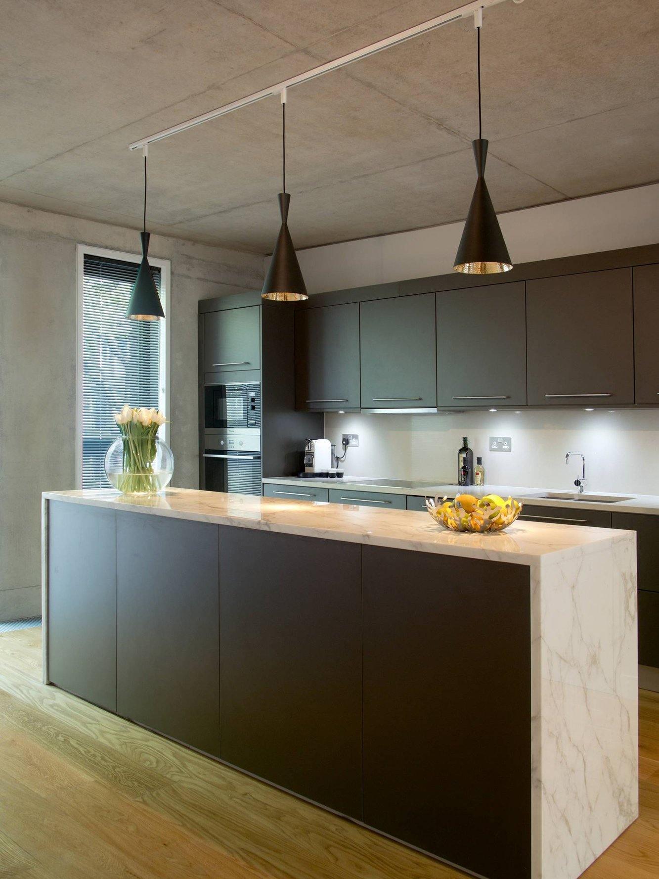 Two tall black cone pendants over a counter