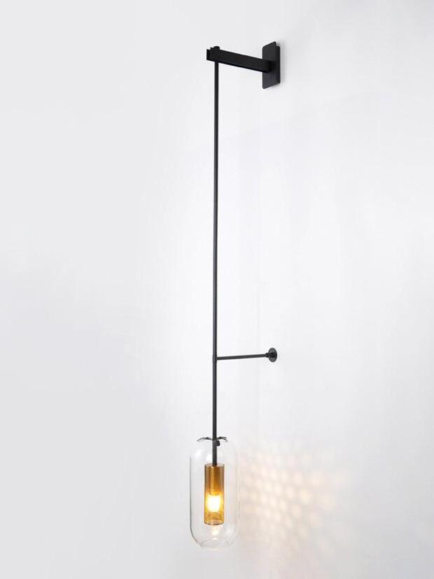 Black Vadim fixture with a rectangular upper bracket and light patterns beside its glass shade