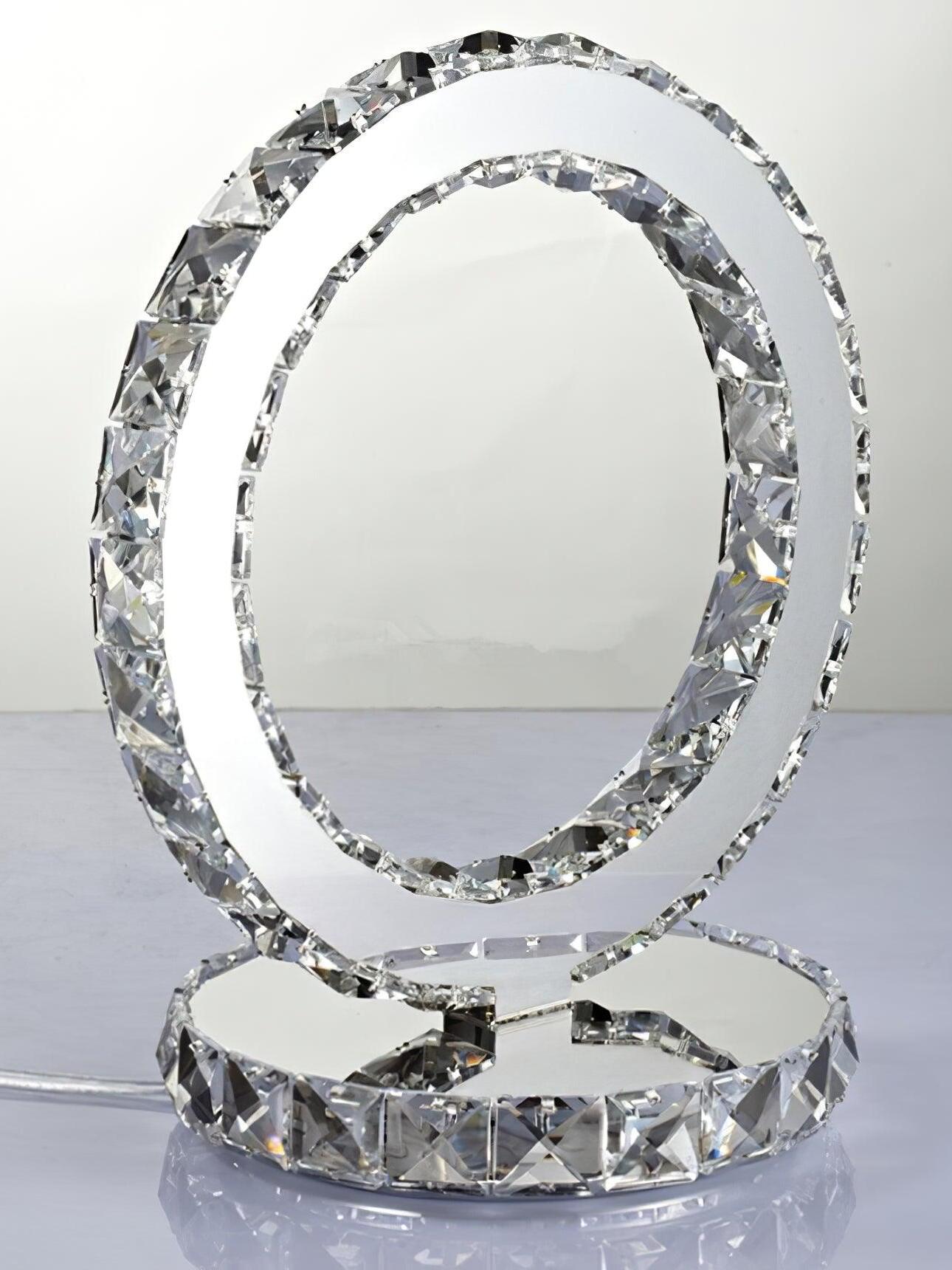 Unlit ring lamp and faceted base on a pale reflective surface