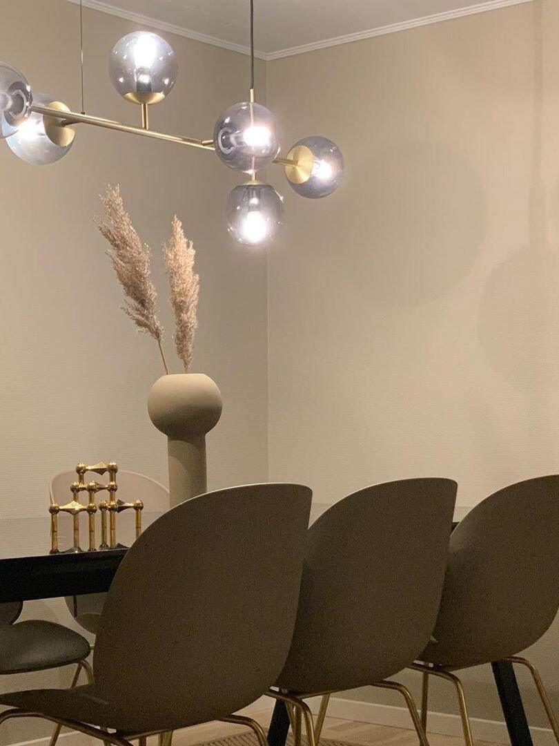 Glass-globe chandelier above a dining table