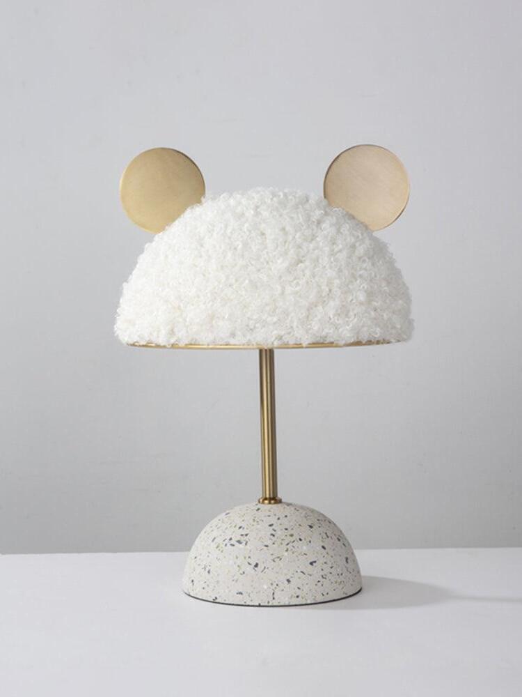 Isolated white plush shade and pale speckled base with gold-tone stem and discs
