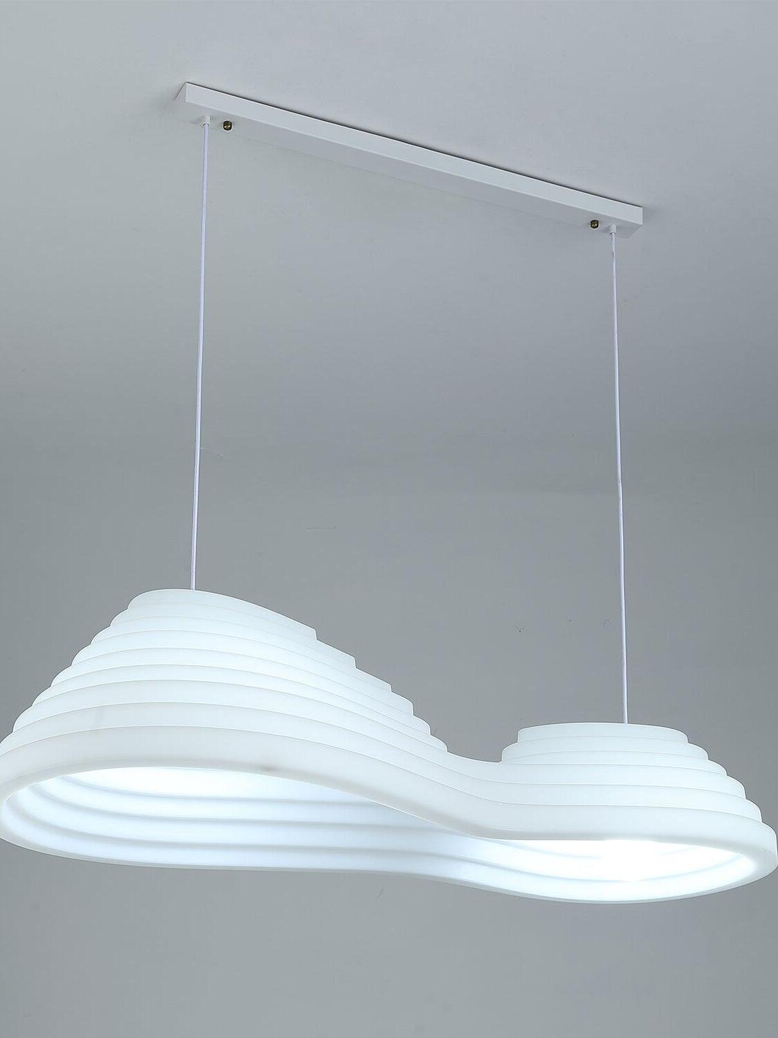 Elongated white pendant lit with a cool-looking glow beneath a rectangular ceiling canopy.