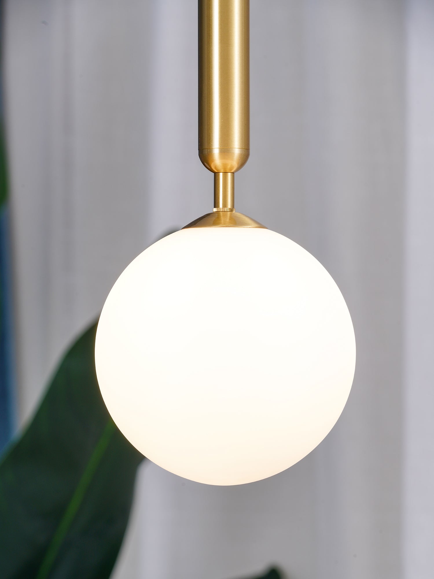 White glass globe and gold-coloured stem close-up