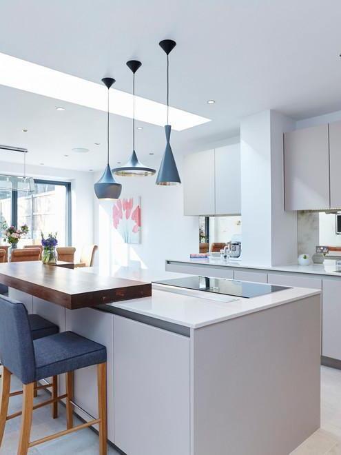Mixed black pendant shapes in a white kitchen