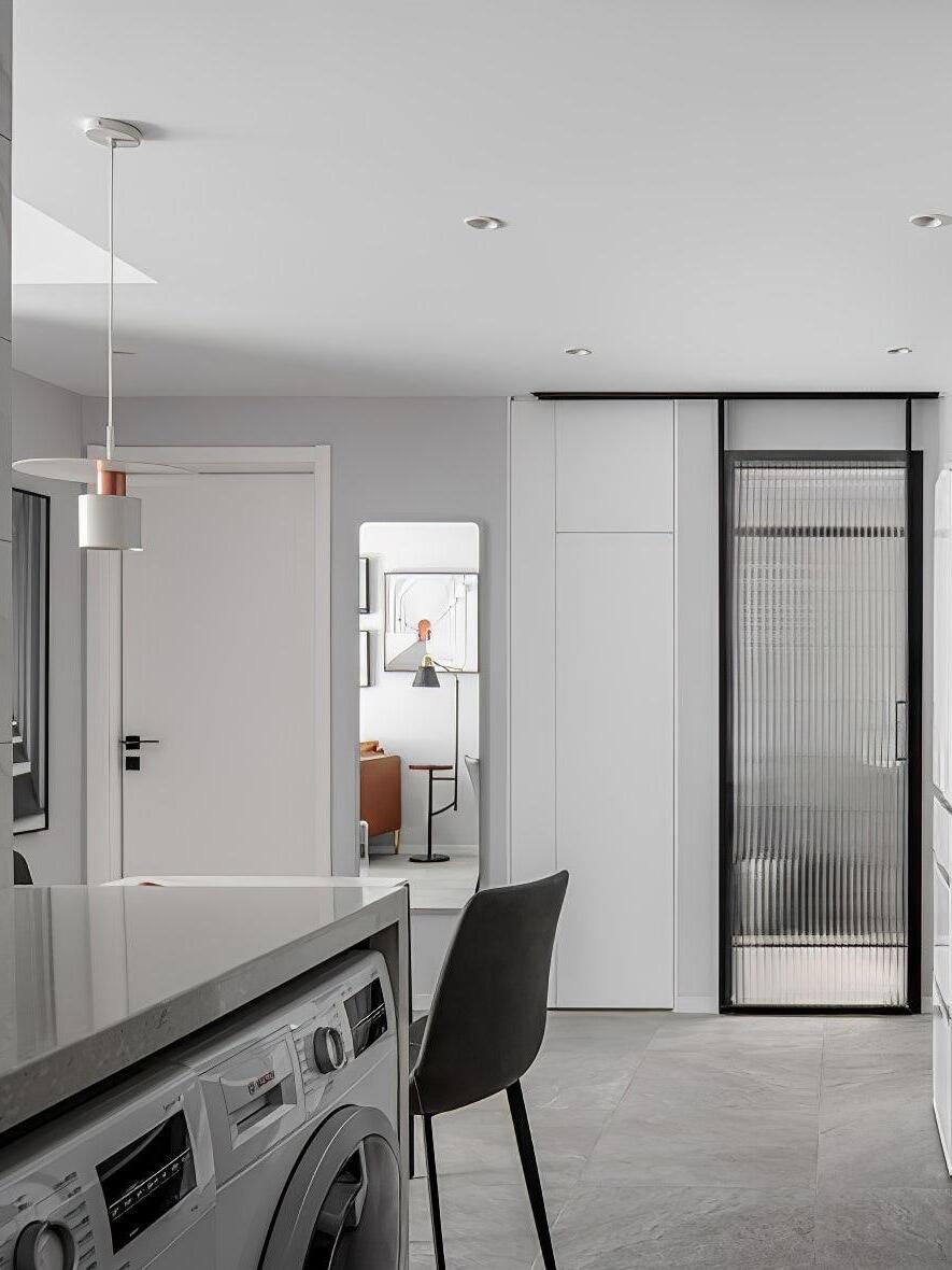 White disc pendant over compact kitchen counter