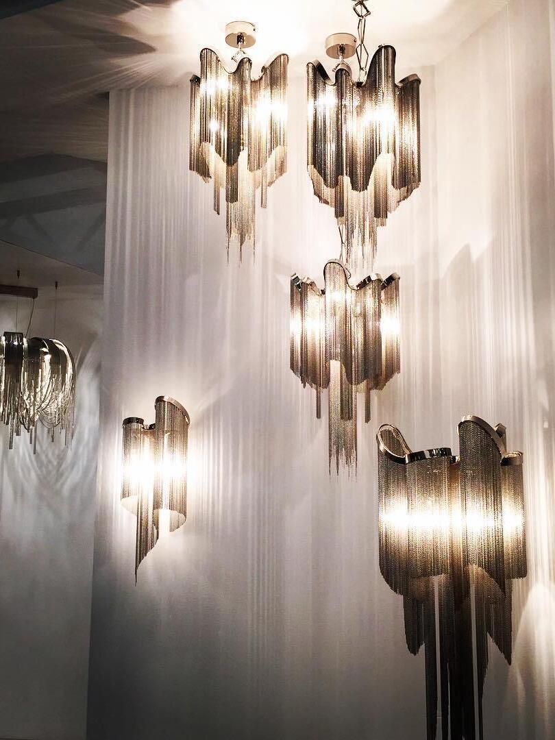 Multiple small chain-fringe lights in a tall interior