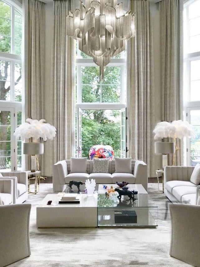 Silver chain chandelier in a tall-windowed living room