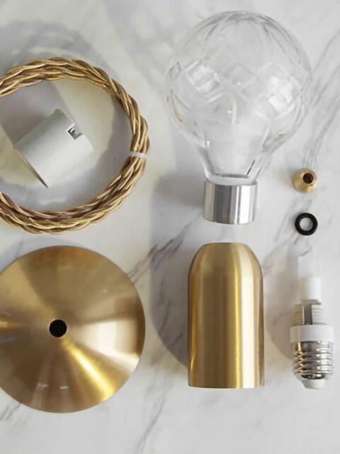 Lamp parts laid out with globe, cylinder, cord, disk and bulb assembly