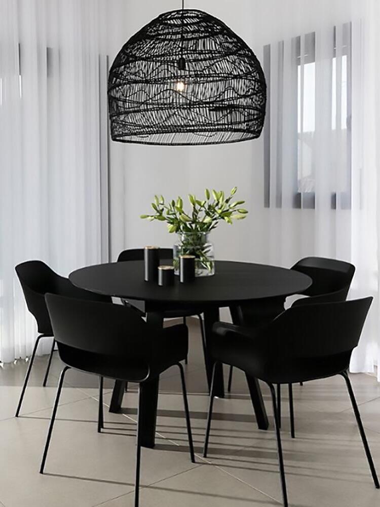 Black woven dome above a round dining table