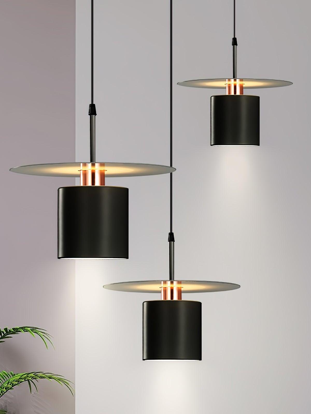 Three black disc pendants suspended in room scene