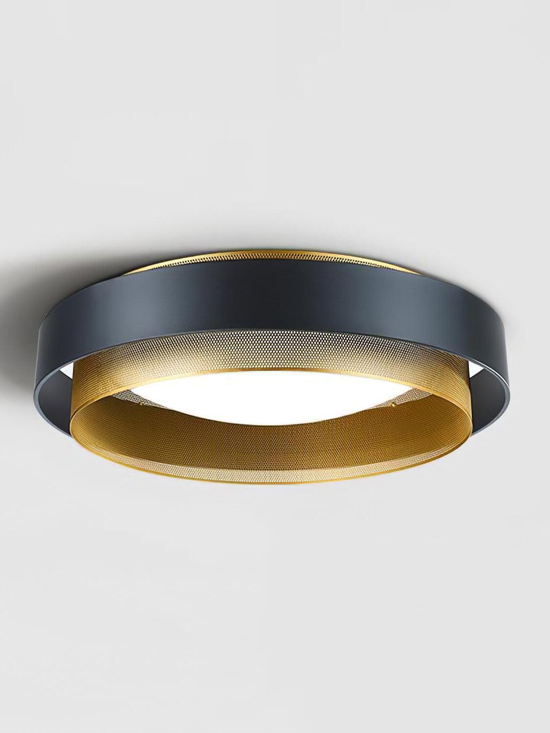 Illuminated Nolan ceiling light with a black outer band and perforated gold ring