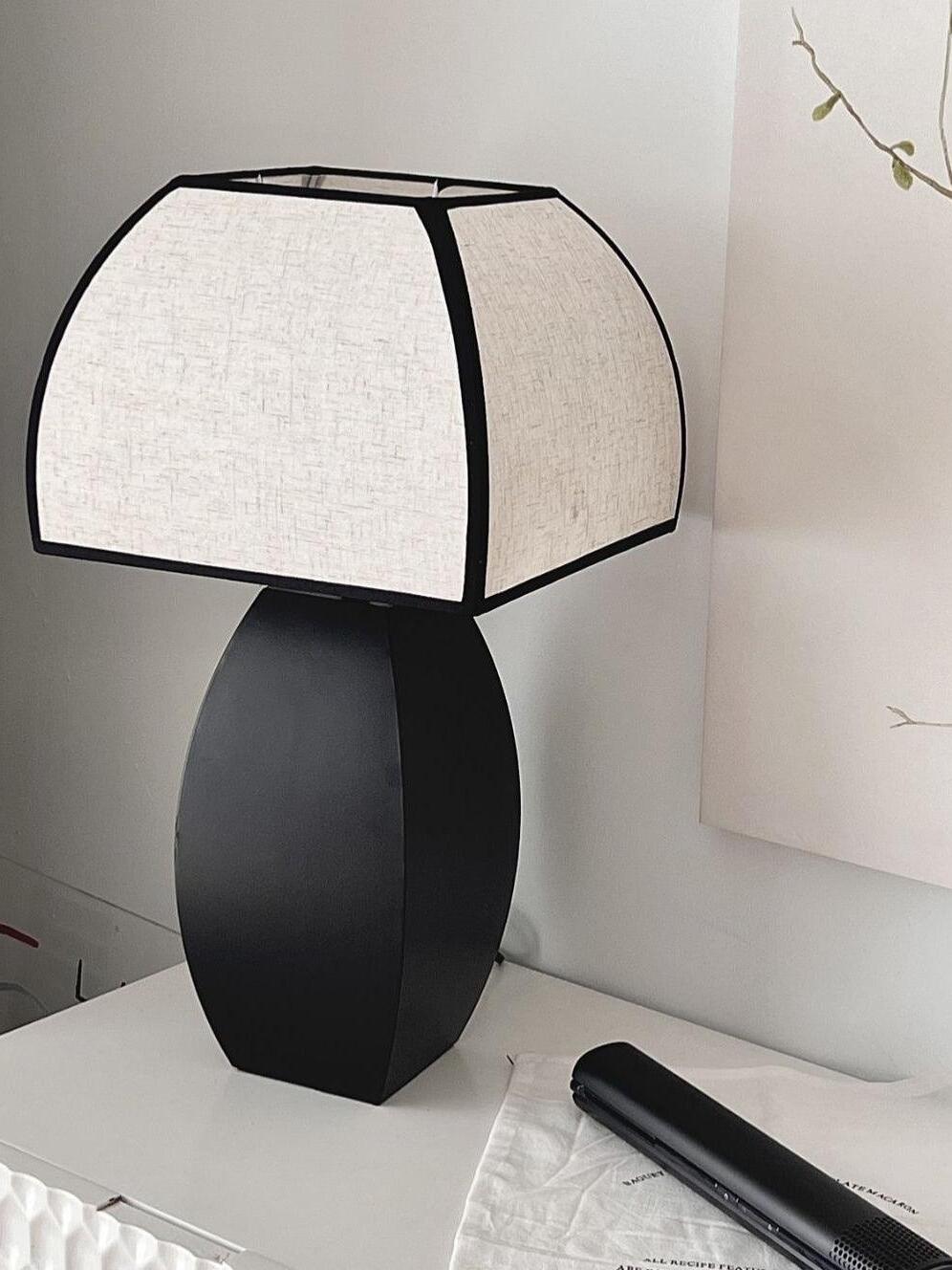 Angled view of Javier fabric shade and black oval base