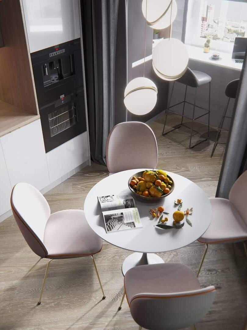 Three lit Crescent globe pendants above a round dining table near kitchen appliances and a window