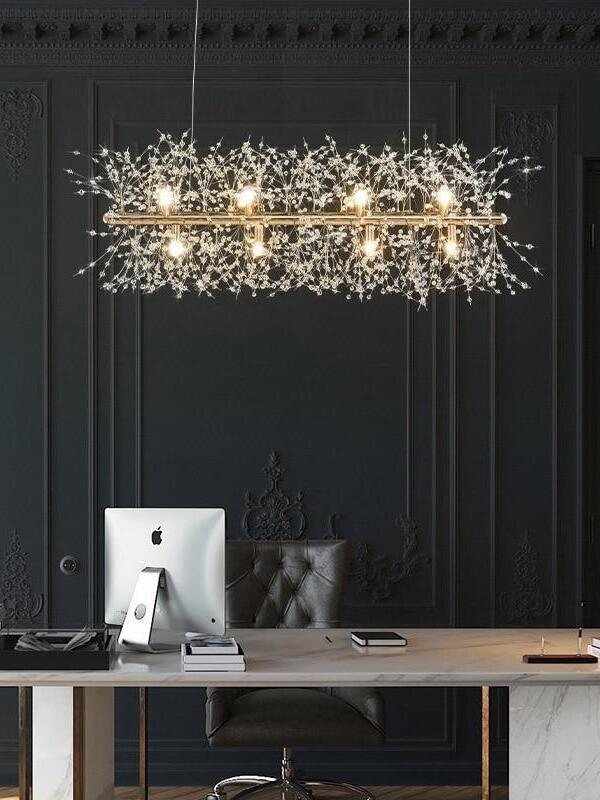 Fireworks chandelier above a desk and computer