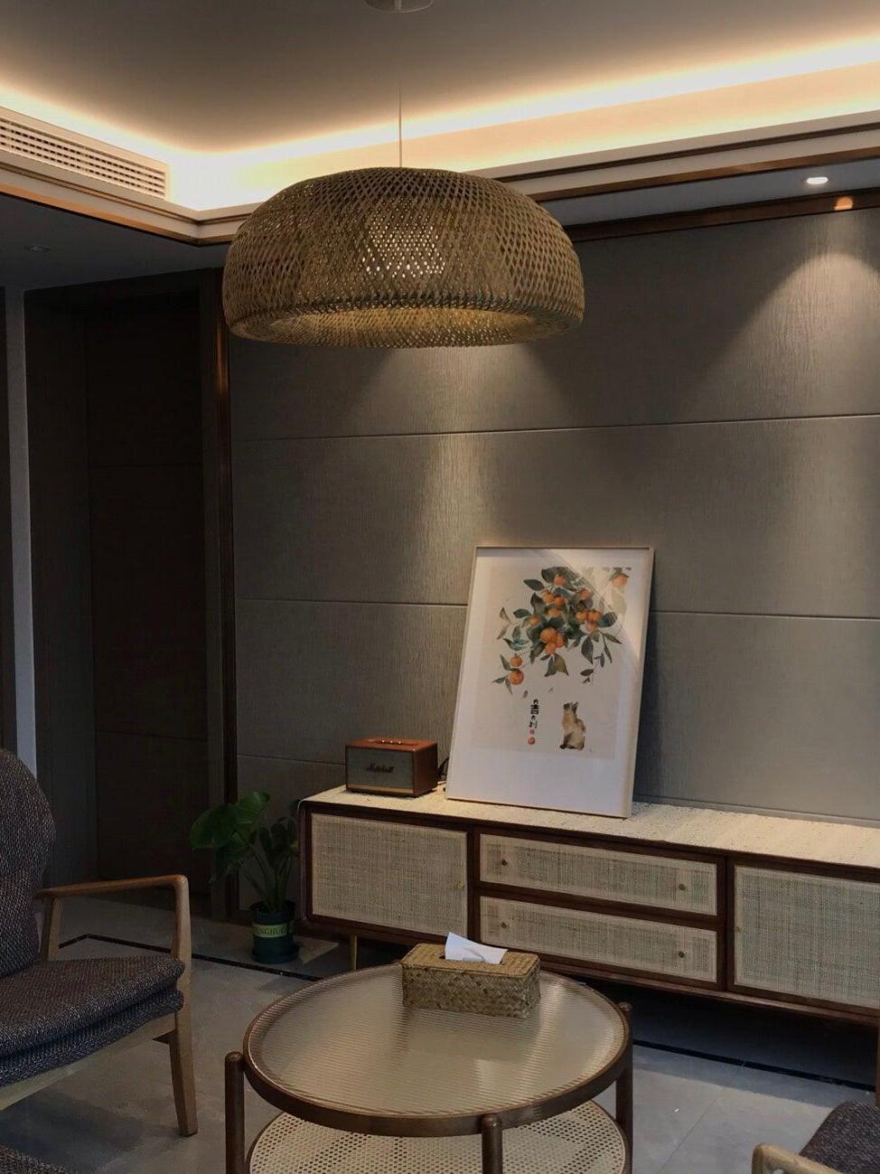 Bamboo pendant over pale table in dim living room