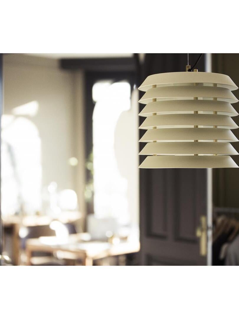 Close white layered shade with vertical spacers and bright room behind