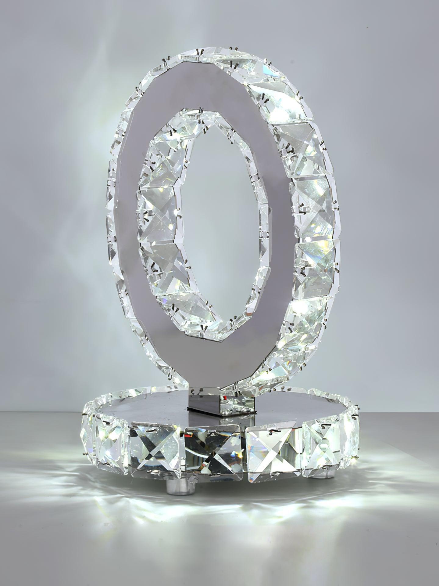 Lit angled ring lamp with bright reflections beneath its circular base