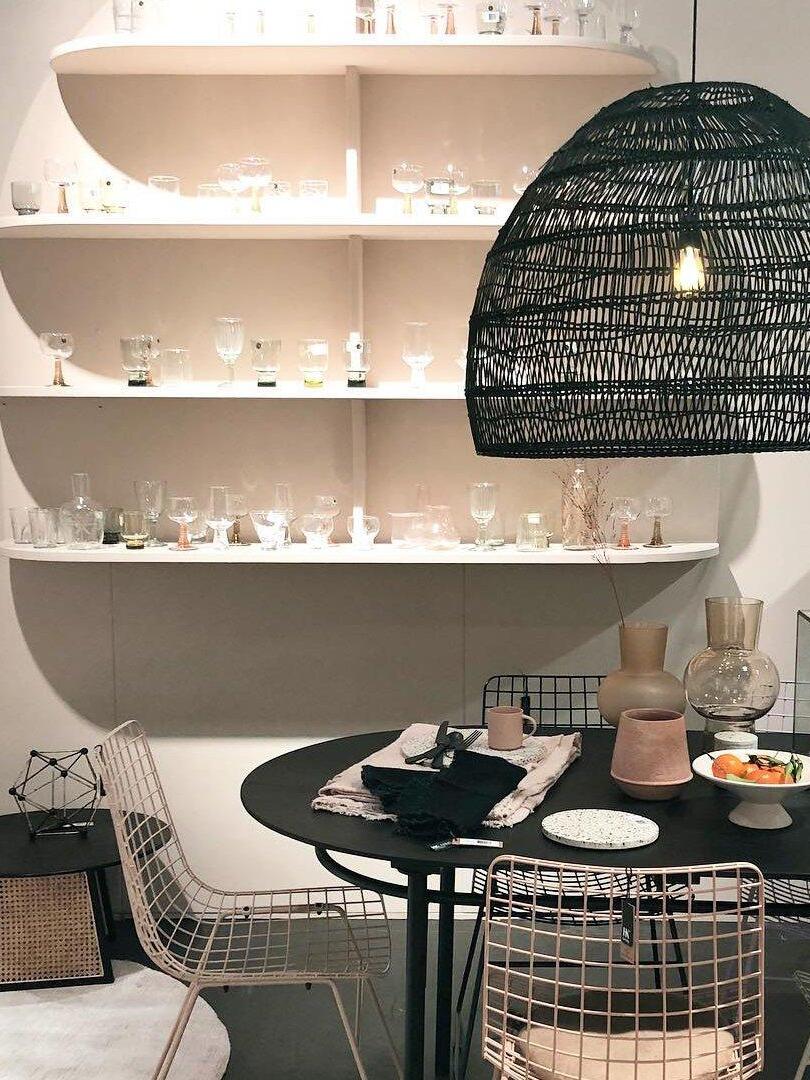 Black woven pendant beside open shelving