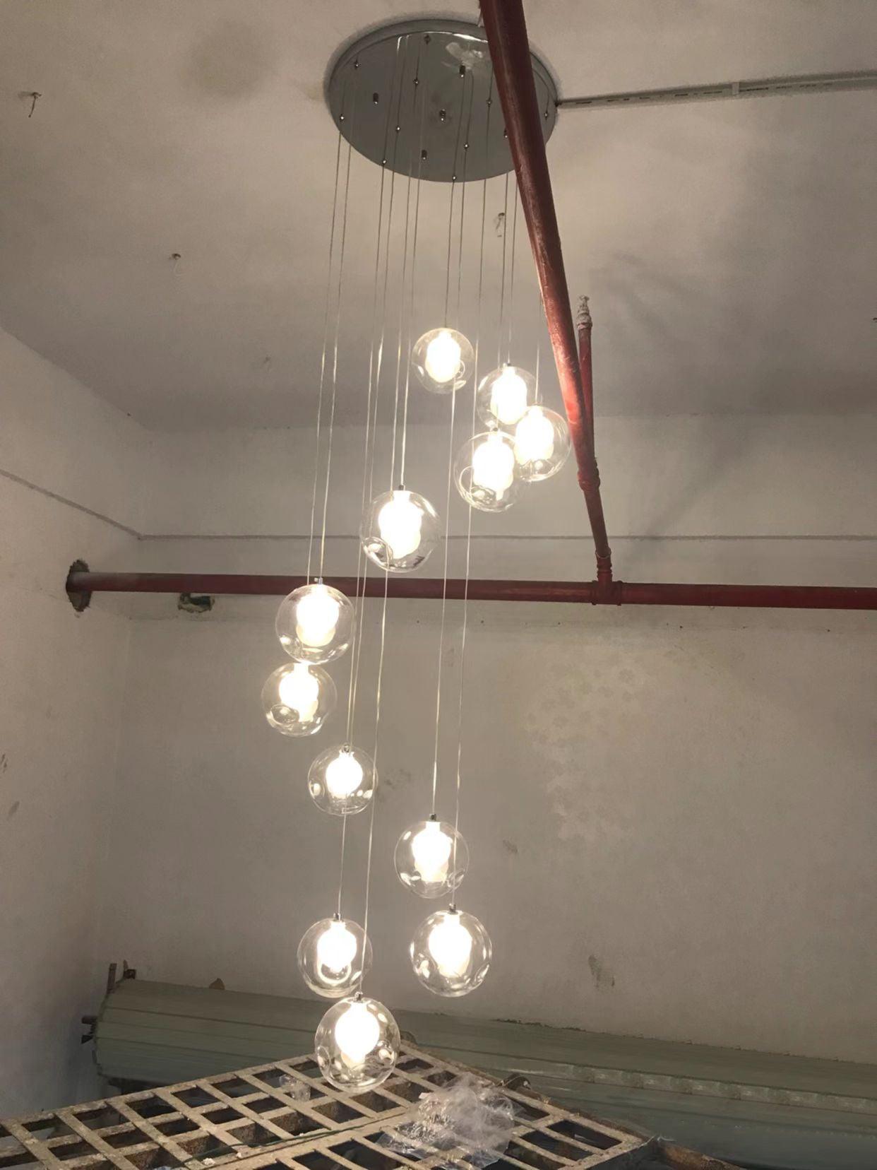 Clear globe pendants on cords in unfinished room