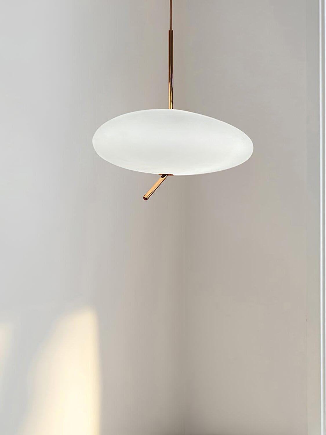 White flattened shade with a rose-gold stem and thin suspension cable against a pale wall