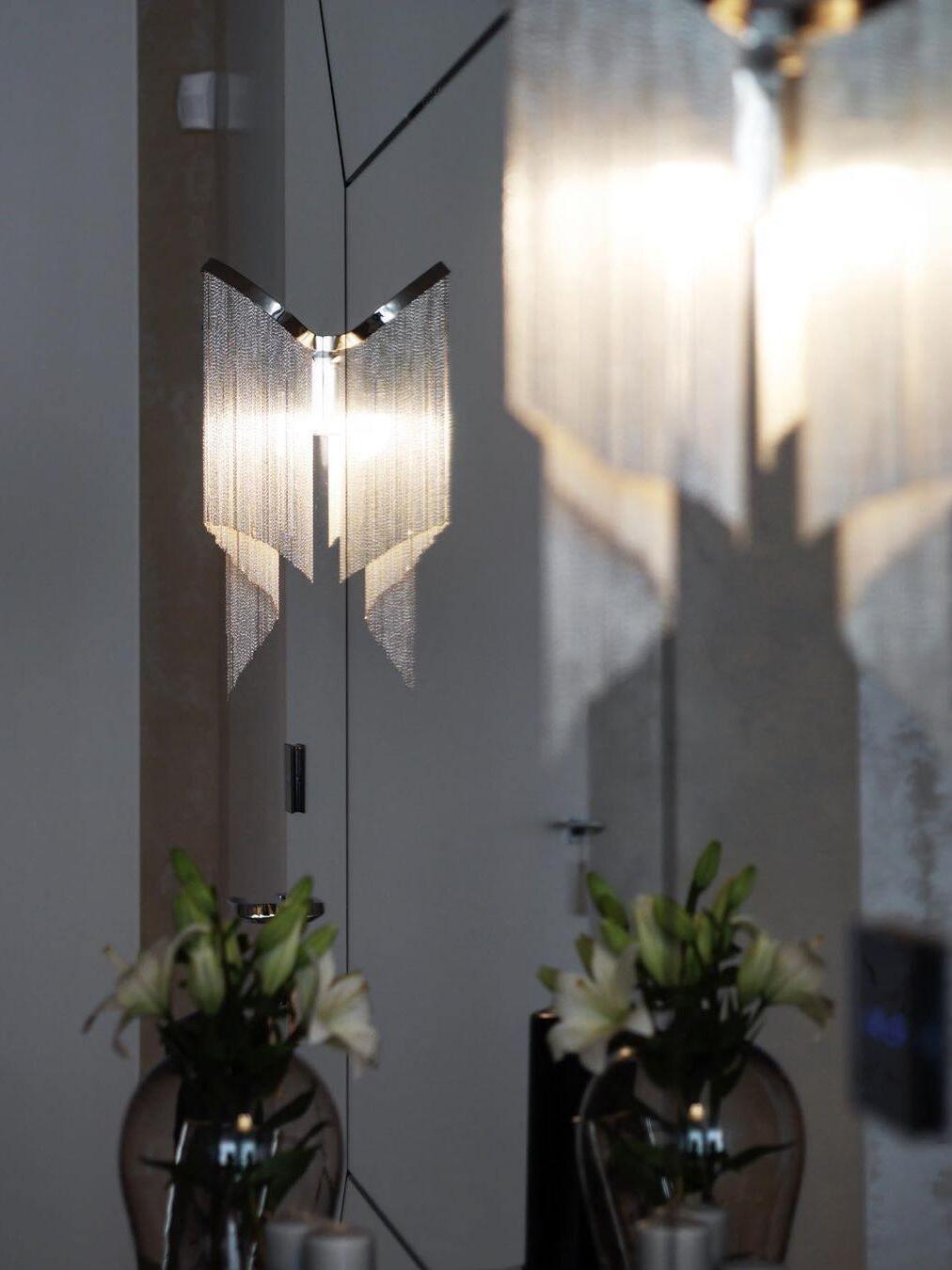 Small chain-fringe fixtures beside a mirror