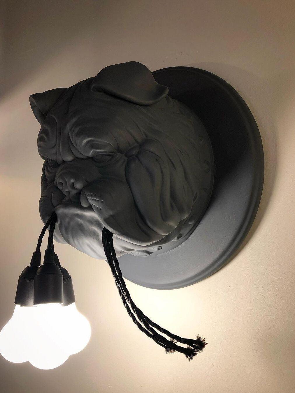 Lit bulbs hanging below a dark bulldog head