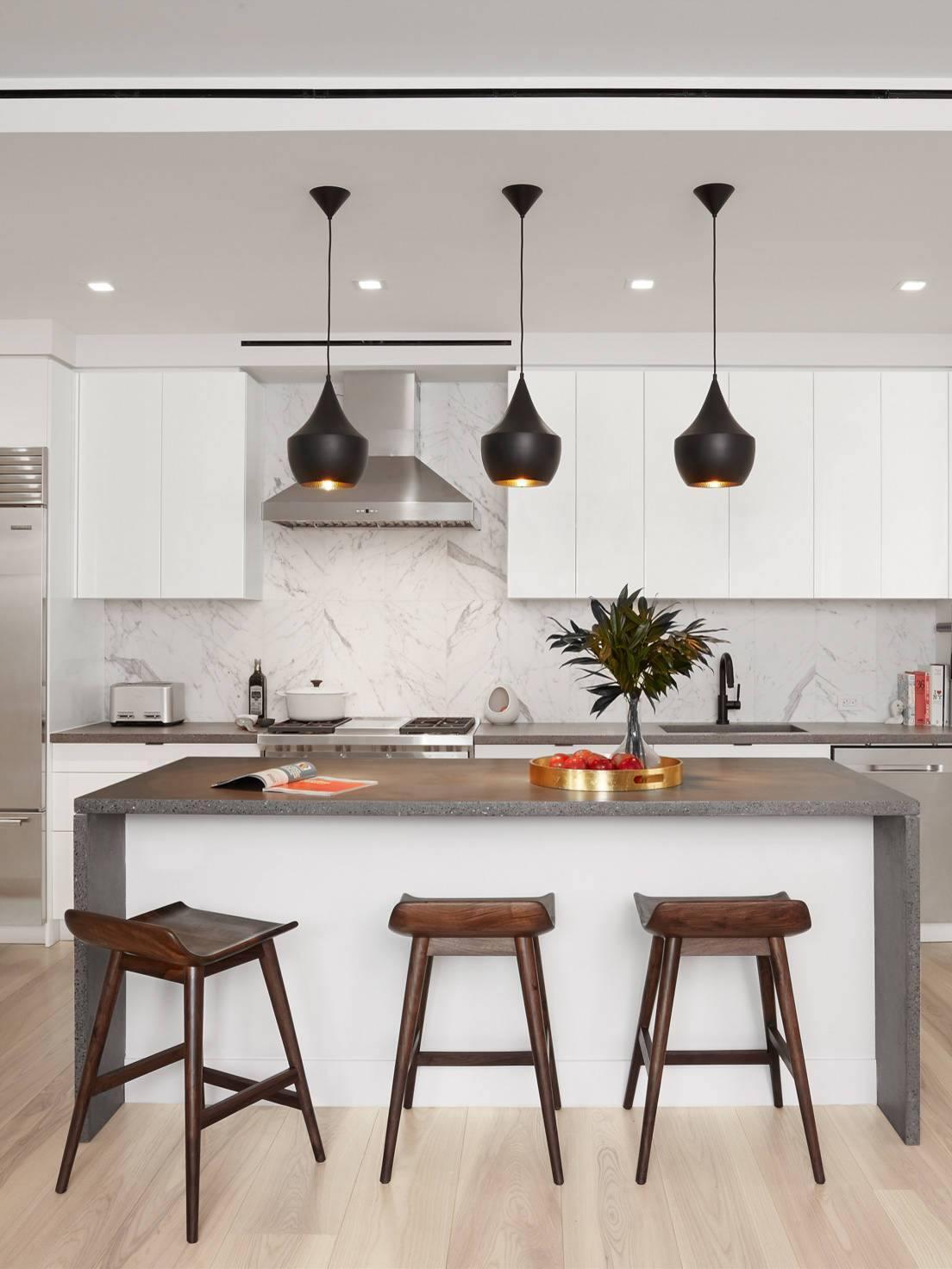 Black rounded pendants over a kitchen counter
