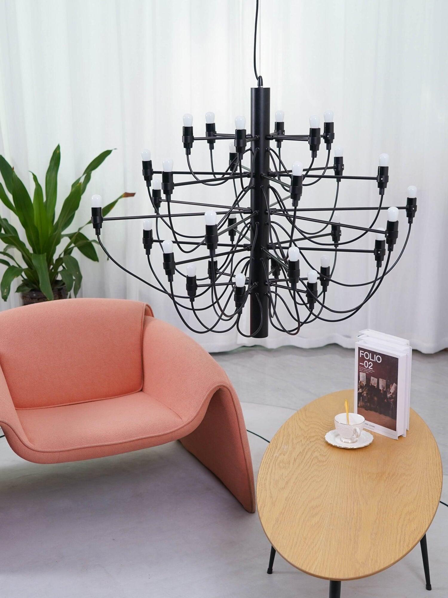 Black chandelier near a pink chair