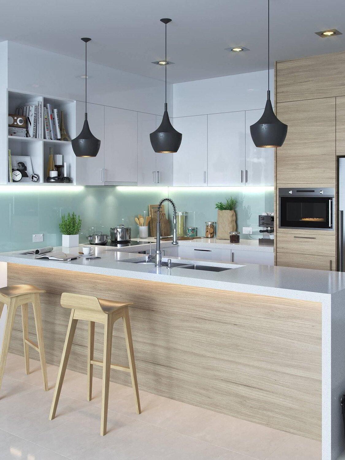 Three black rounded shades over a kitchen island