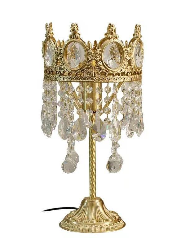 Crystal table lamp with an open-top ornate crown, layered lower drops and a fluted round base.
